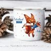 Auf dem Bild ist das Produkt: Campingbecher Emaille personalisiert Fuchs mit Schultüte Wunschname Einschulungsgeschenk zum Preis von €18.9 abgebildet.